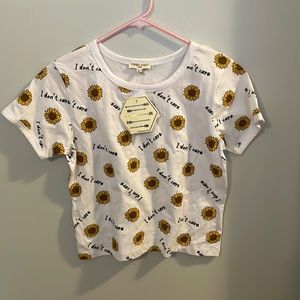 New Tee shirt with flower print and “i don’t care” message.